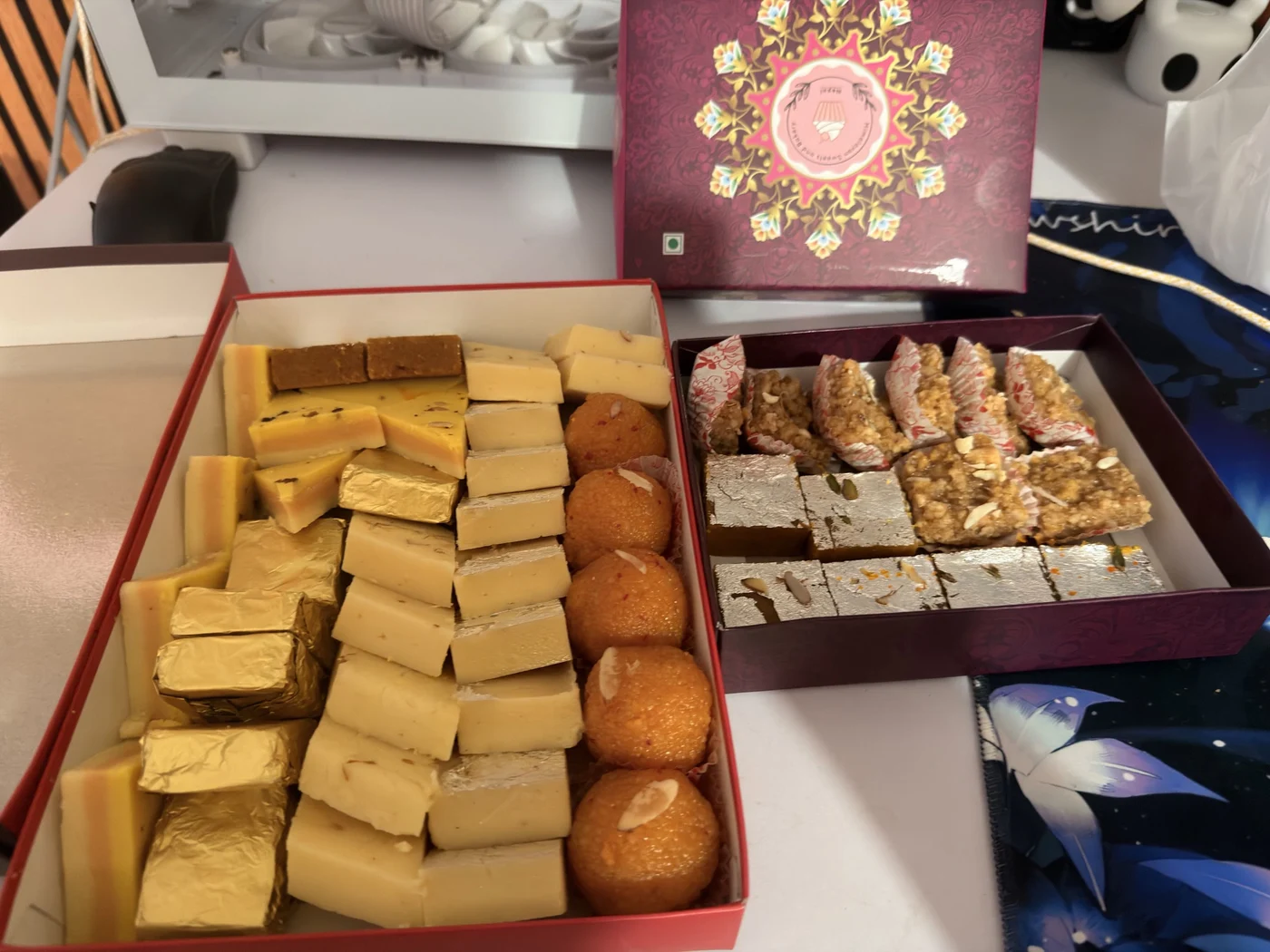 Two open boxes filled with assorted sweets
